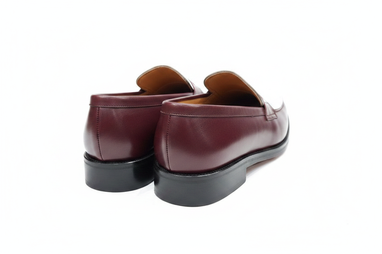 Paire de mocassins bordeaux blanc vue arrière en plongée contreforts et talons noirs sans embauchoirs sur fond blanc pur